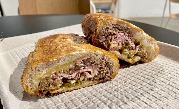 Cubano sandwich made with homemade mojo pork, prosciutto cotto, Swiss, spicy mustard, and pickles. Huge and delicious!