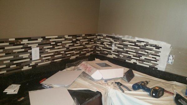 Installing backsplash on the kitchen. ..