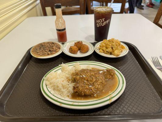 Chicken fried steak, rice, black eyed peas, hush puppies, Mac and cheese, homemade hot sauce, iced tea