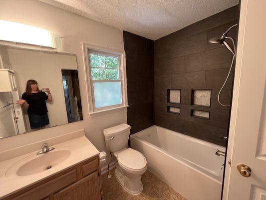 They did the tile around the shower, in the shampoo niches, and painted