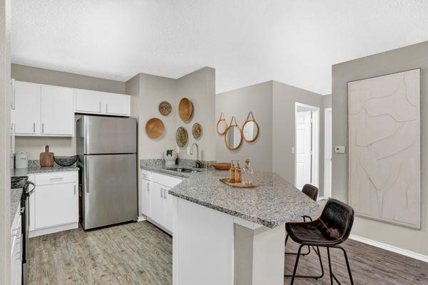 Kitchen with stainless steel appliances at Carrollton Park of North Dallas