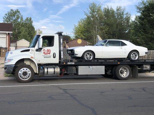 Our flatbed truck hauling a doge charger.