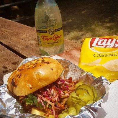 Pulled pork with an apple/kale-slaw served on jalapeno cheddar buns.