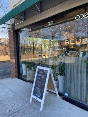 Welcome sign outside the coffee shop