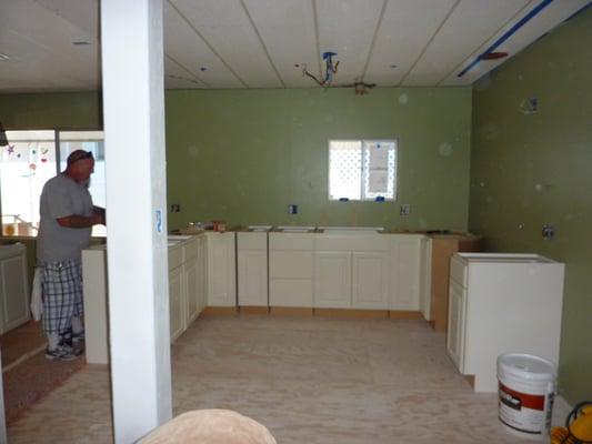 Day 8 - Dan making sure the cabinets are going to fit right before the counters get here to be installed.