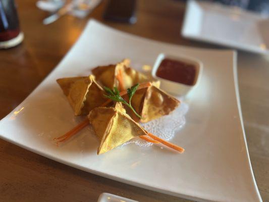 Crab Rangoon. Crisp and flaky with a rich creamy filling. Sweet and spicy Thai chili sauce on the side.