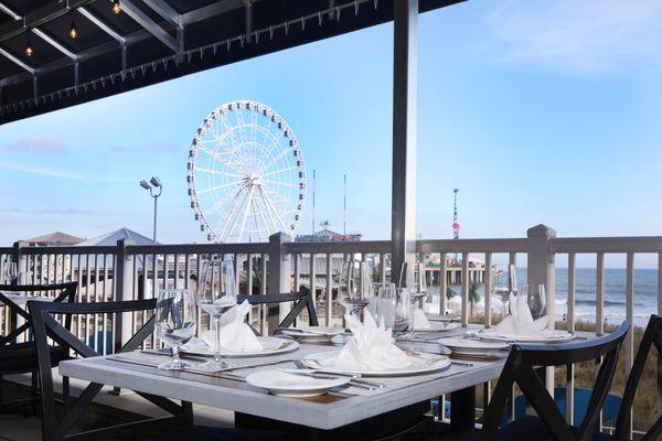 Dine amidst history. Dine al fresco above the historic boardwalk with a view of the iconic Steel Pier and beach.