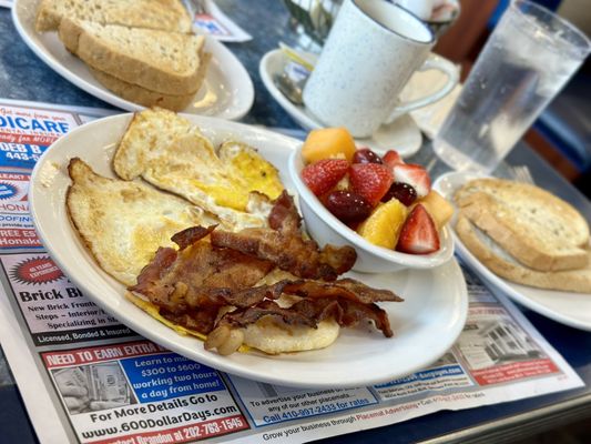 Eggs, bacon and fruit with toast and a coffee.  Pretty good stuff.