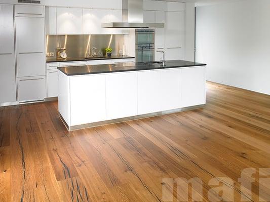 I love the juxtaposition of the warm hardwood floor with the stark, clean lines of the cabinetry.