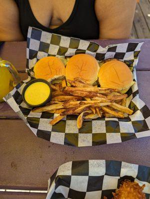 Close up of Sliders with honey mustard and fries