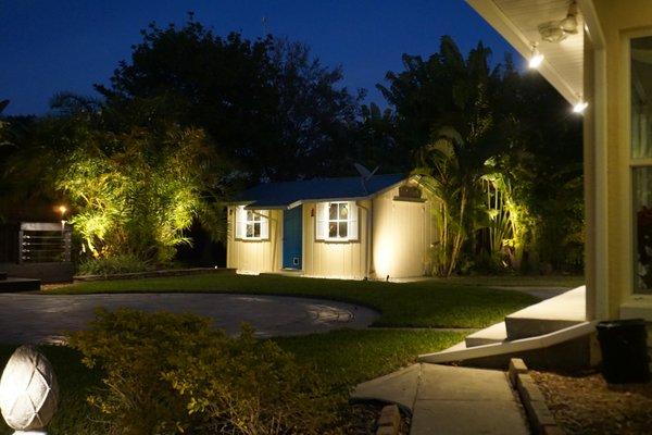 An assortment of hi-quality brass Up Lights and Down Lights accent the shed and surrounding Areca and Traveller's Palms.