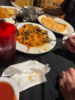 Pasta with mussels and shrimp, chicken tenders and fries