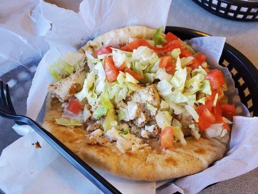 Greek chicken pita with diced tomatoes, lettuce, feta and tziziki.