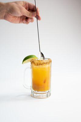 Mango Punch Michelada: mango, lime Valentina, Tajín chili salt, Two Robbers Mango Punch.