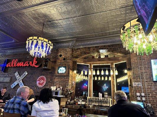 Bar view. Love how they repurposed the bottles for lights and a radiator for the beer taps.