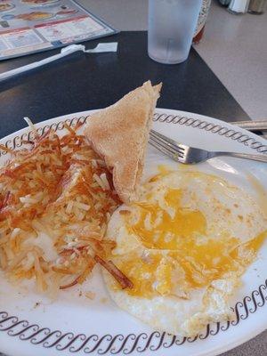 Eggs over easy with hash browns and toast