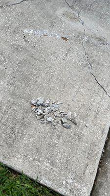 Fragments, gouges and new cracks on my driveway, caused by the placement of Sheegog's waste dumpster.