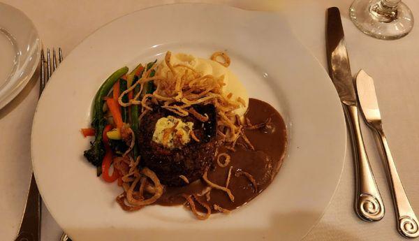 Beef Tenderloin filet mignon with mashed potatoes, mushroom gravy, and vegetable spears and fried onions.