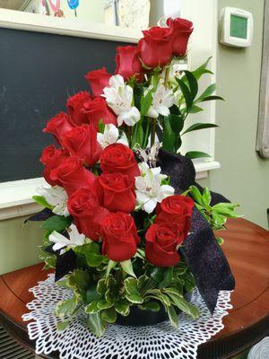 Classy Red Roses with white alstomeria in a spiral design.