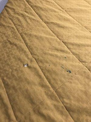 Cigarette burns on the bedspread. Classy.