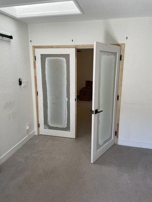 Double door with frosted glass between owner's suite and room addition, which is used as my office.