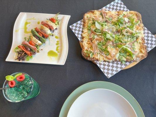 Mint water, antipasto skewers, and arugula and prosciutto pizza