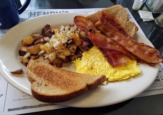 2 scrambled eggs, home fries with onions, bacon an wheat toast. Coffee.