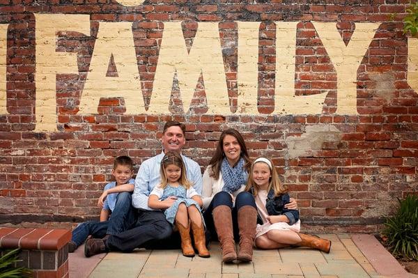 JAX TOYS is locally owned and operated proudly by the Eubanks family!  Here is a shot of us against the wall of our store!