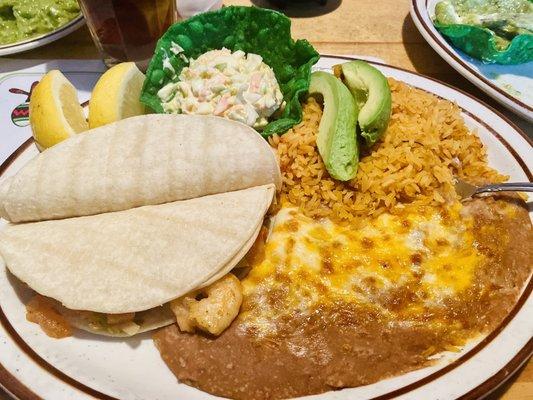 Shrimp tacos with rice and beans.