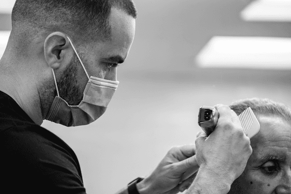 One of the barbers performing a traditional haircut