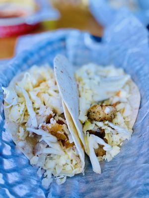 One Fried mahi mahi taco & One blackened shrimp taco. They come w/sour cream lime & cilantro sauce.