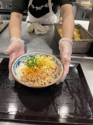 Kitchen person giving you your Nikutama Udon