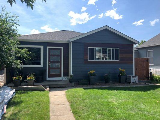 Siding replacement with Brazilian Ipe wood accents around the front window and door