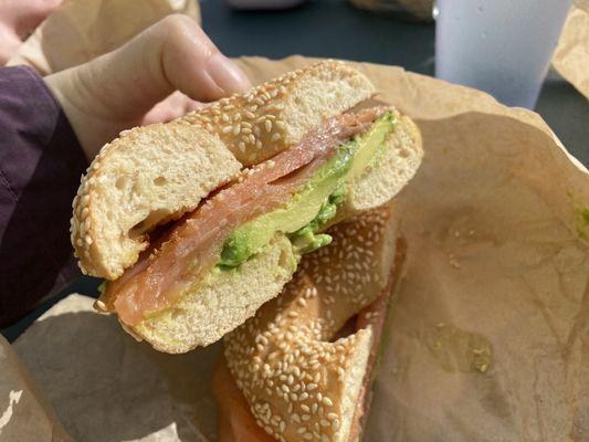 Sesame bagel with avocado and lox