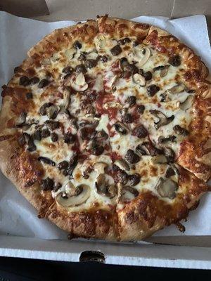 Large pizza with ground beef and mushrooms. Yum nice and hot