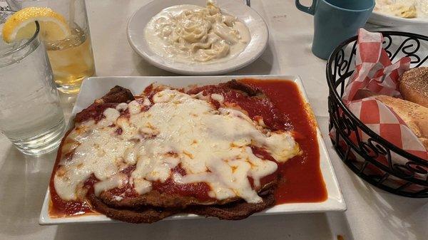 Eggplant Parmesan entree with a side a fettuccine Alfredo.