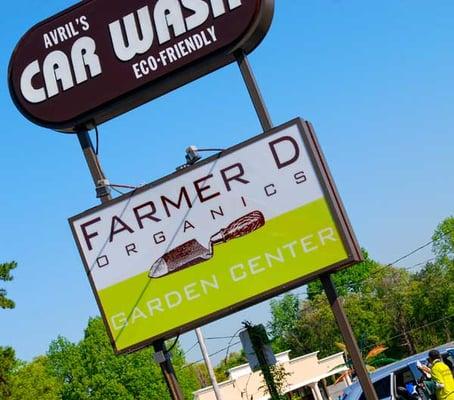 Farmer D Organics store sign along with Avril's Car Wash.