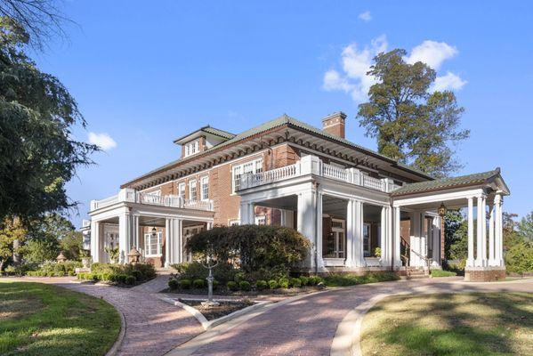 Front/Side angle featuring gracious porches and porte-cochère