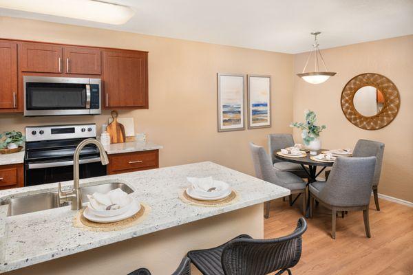 Dining room with plank flooring and kitchen at The Palisades in Paradise Valley