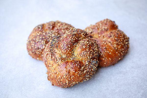 Everything Knot - A fluffy, savory knot formed from our challah dough and topped with everything bagel seasoning.