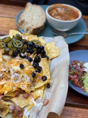 Nachos with chicken and bowl of chili