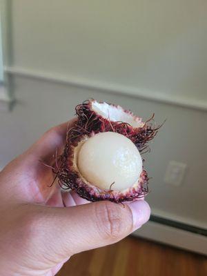 Inside of a rambutan fruit, delicious. There's a pit in there.