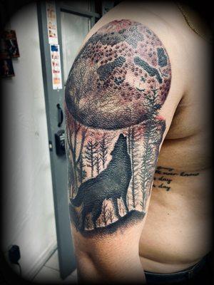 Wolf with a full moon tattoo done by alien.