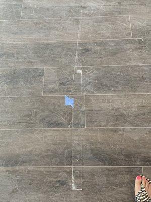 chipped, scratched floor tile, missing grout