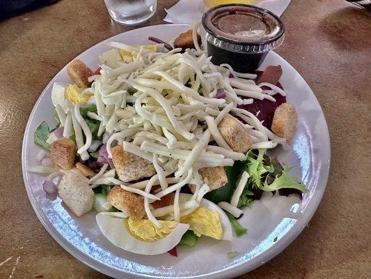 Small house salad with cheese, eggs, and balsamic vinaigrette dressing