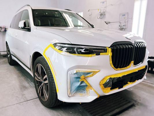 Front bumper repair and painting after a collision accident for a white BMW SUV at Best Auto Body & Paint in Baltimore, MD