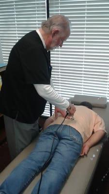 Dr. Stakes using The Activator Method Technique to adjust a patient.