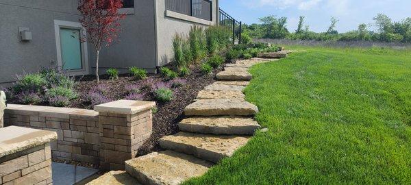 Loch Lloyd new landscape, walls, steps, sprinkler , and steps by Tuff Turf