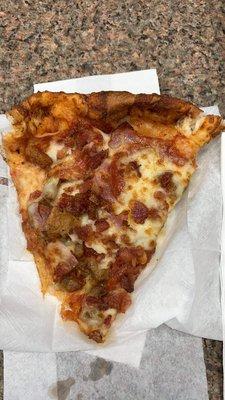 A slice of the "Nice to Meat You" pizza.