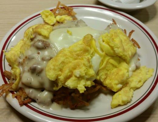 Smothered biscuit with sausage, sausage gravy, scrambled eggs, hashbrowns and white American cheese